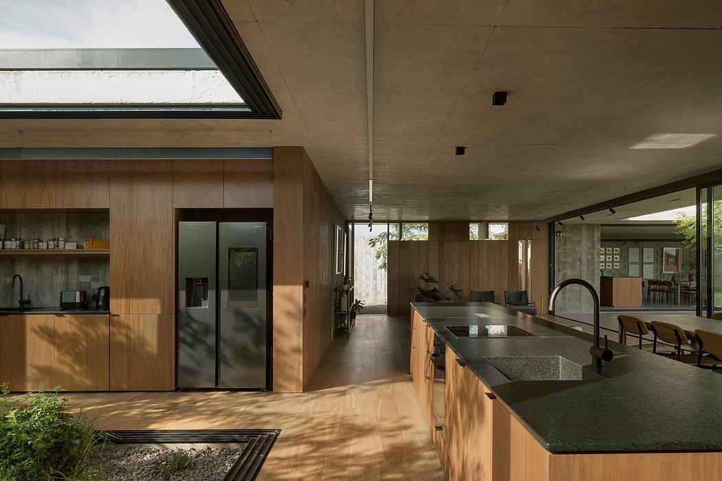 Sleek, modern kitchen with wooden cabinetry, concrete ceilings, and expansive windows.