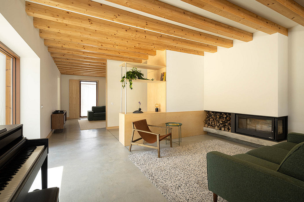 Warm, wood-paneled ceiling complements sleek, minimalist furnishings in this cozy living space.