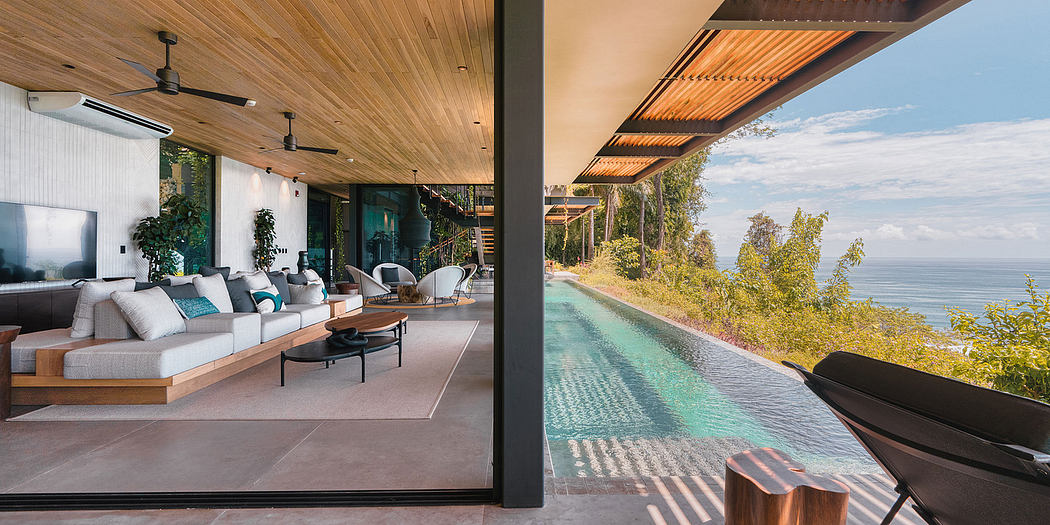 An open-concept living room with a stunning infinity pool and scenic ocean views.