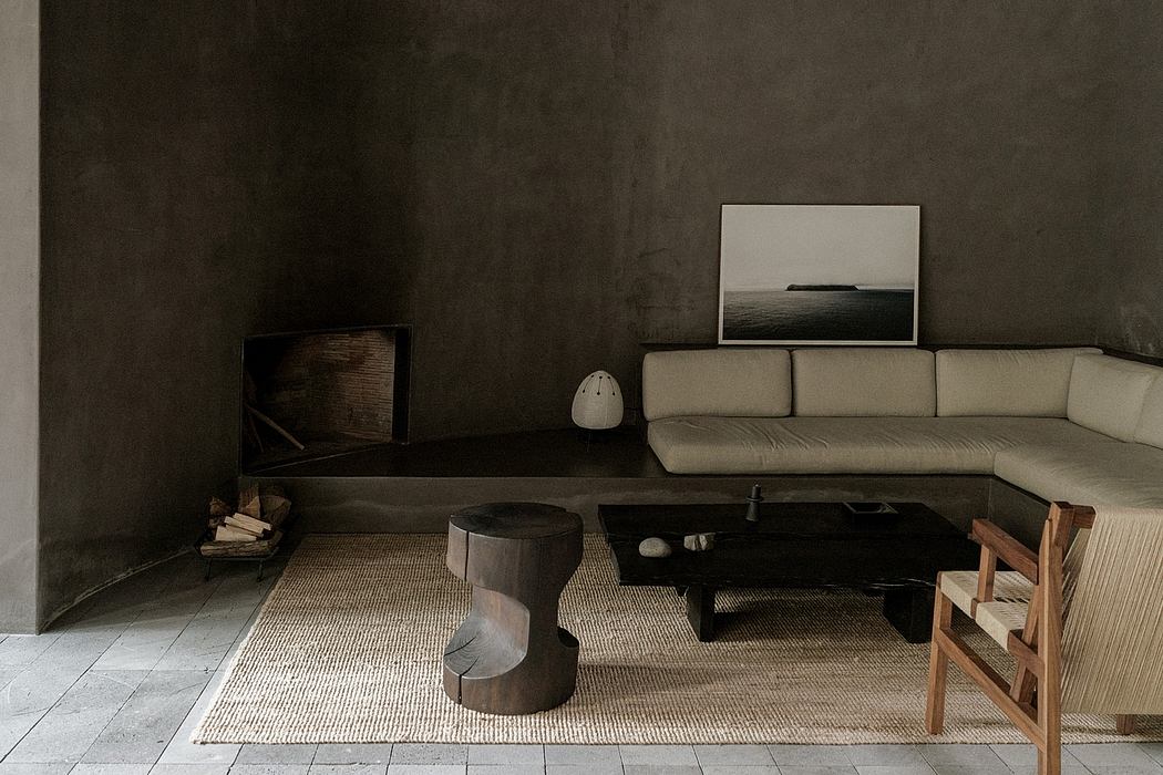 Minimalist living room with dark walls, wood furniture, and a landscape artwork.