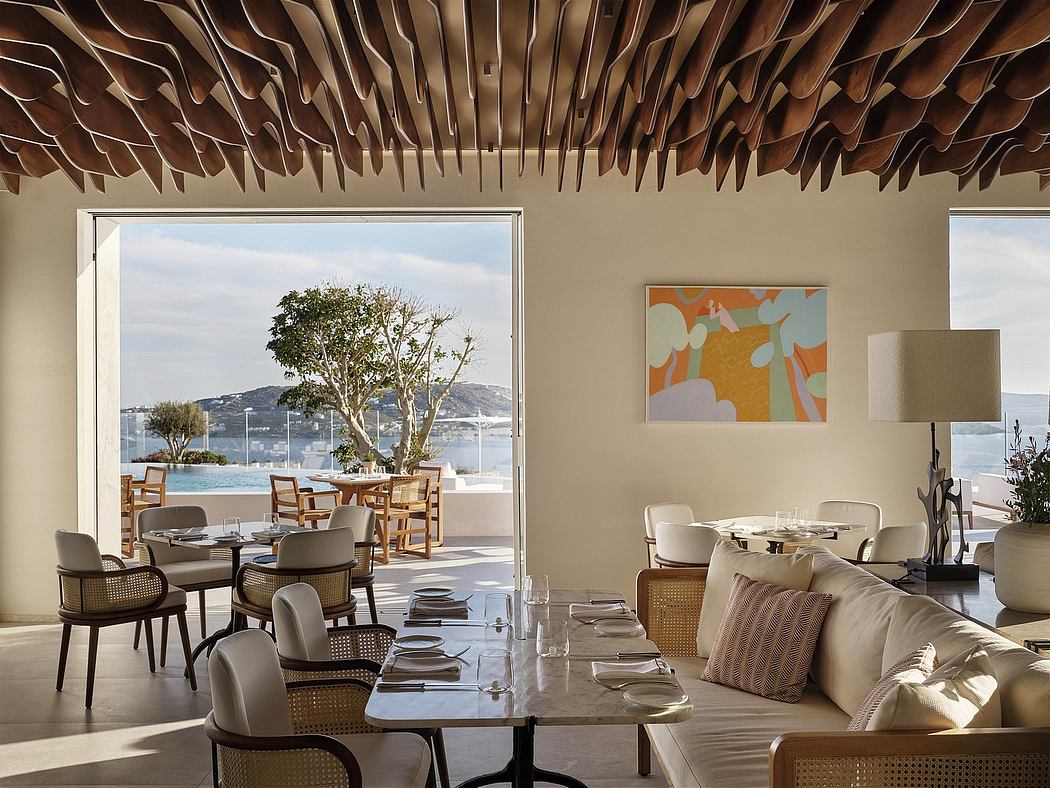 Warm, modern interior design with wooden ceiling panels, comfortable seating, and scenic ocean view.