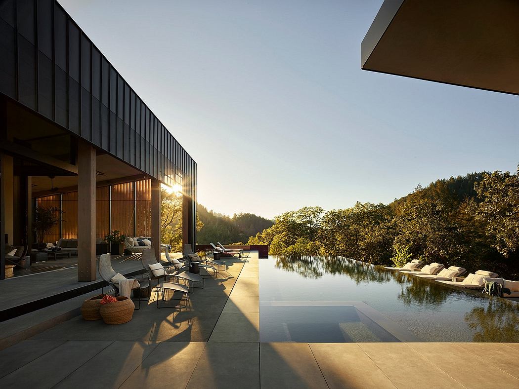 A stunning modern architectural design with an infinity pool reflecting the surrounding nature.