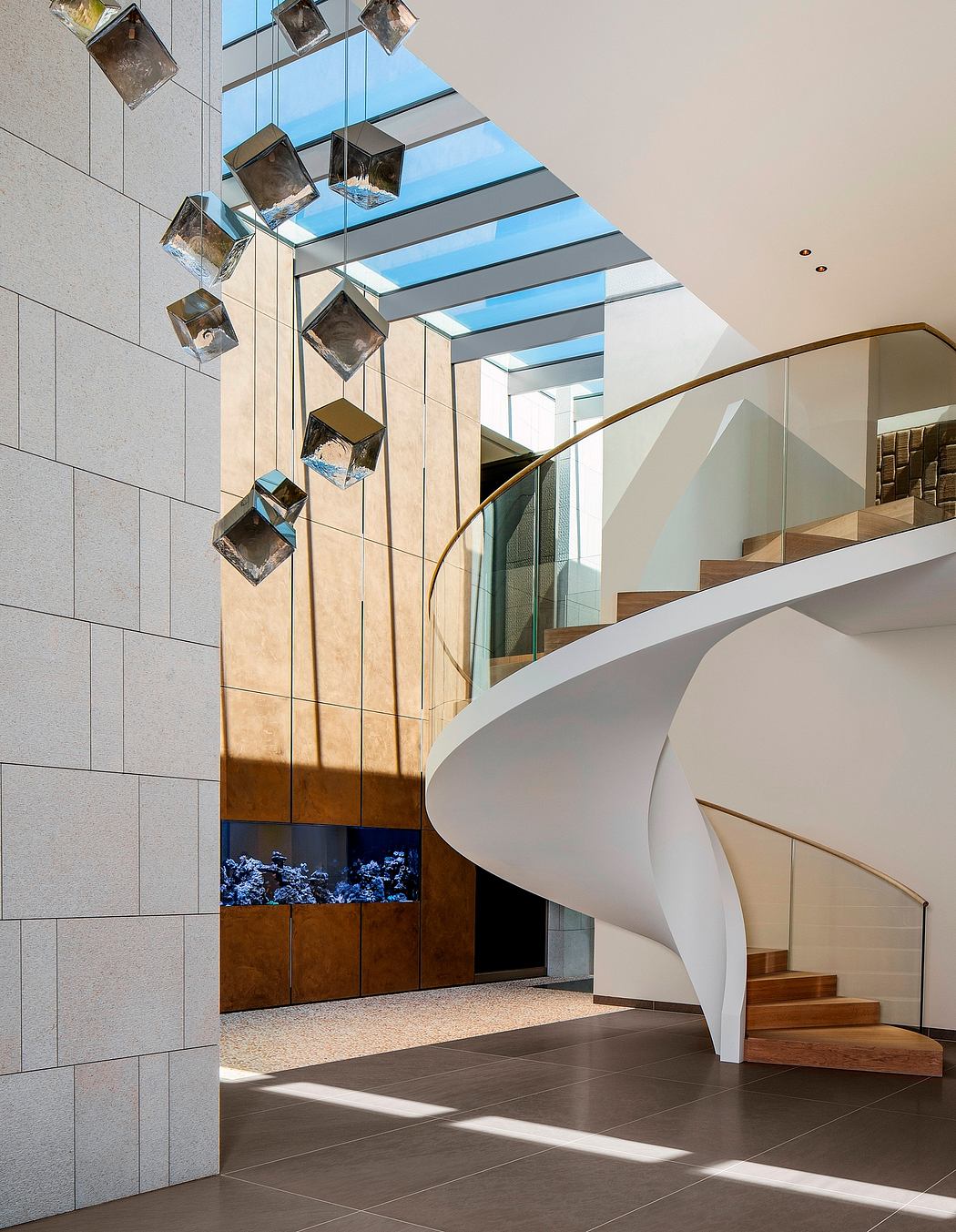 Modern, airy interior with glass panels, geometric lighting, and a spiral staircase.