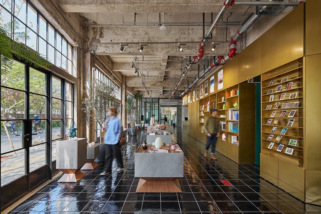 A modern industrial-style interior with concrete walls, track lighting, and display shelves.