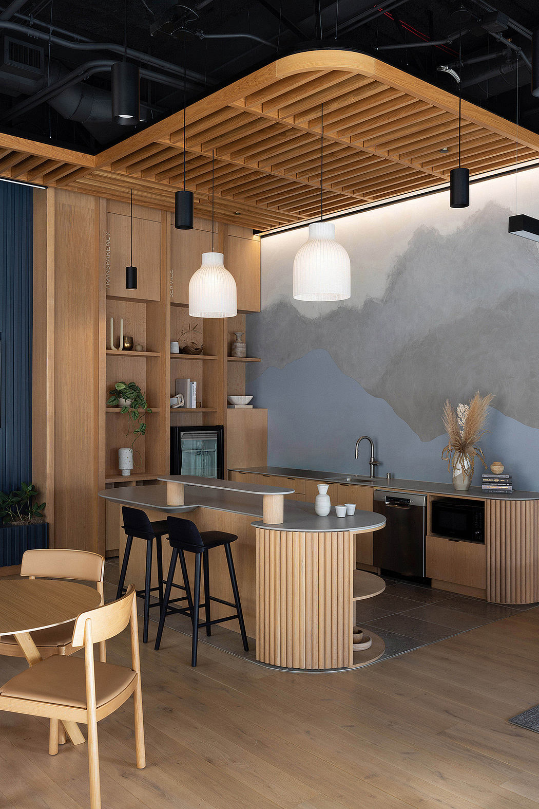A modern kitchen with a clean, minimalist aesthetic featuring wood, concrete, and pendant lighting.