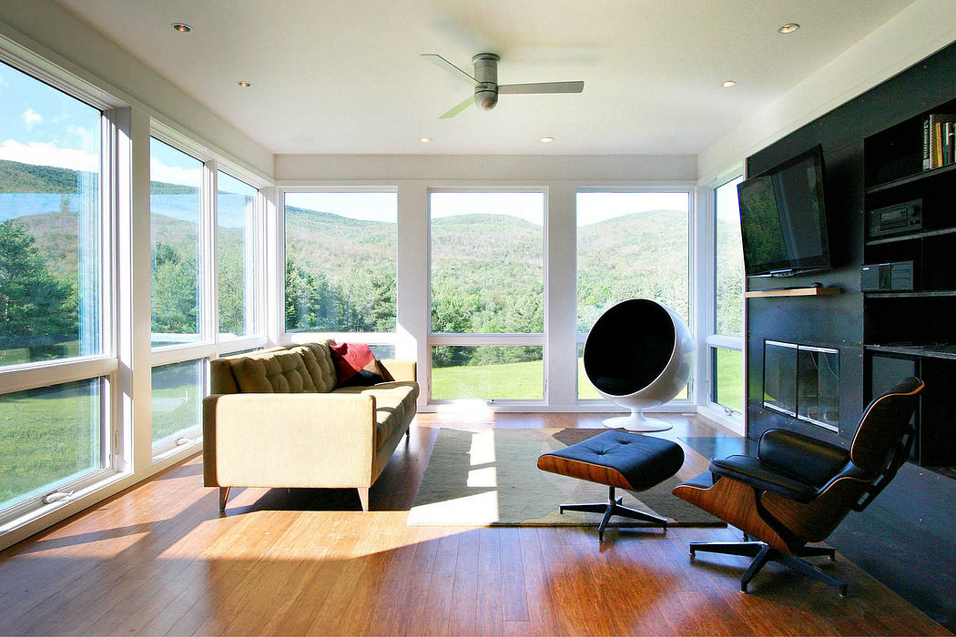 Spacious living room with panoramic mountain views, modern furnishings, and large windows.