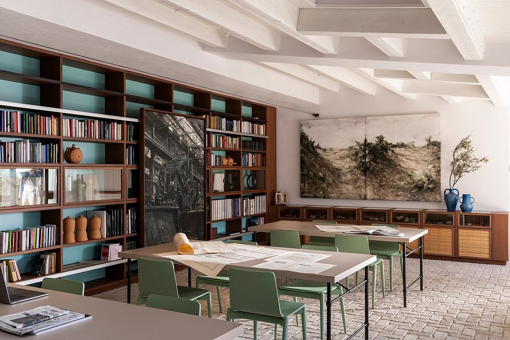 Spacious library with soaring ceilings, built-in bookshelves, and earthy accents.