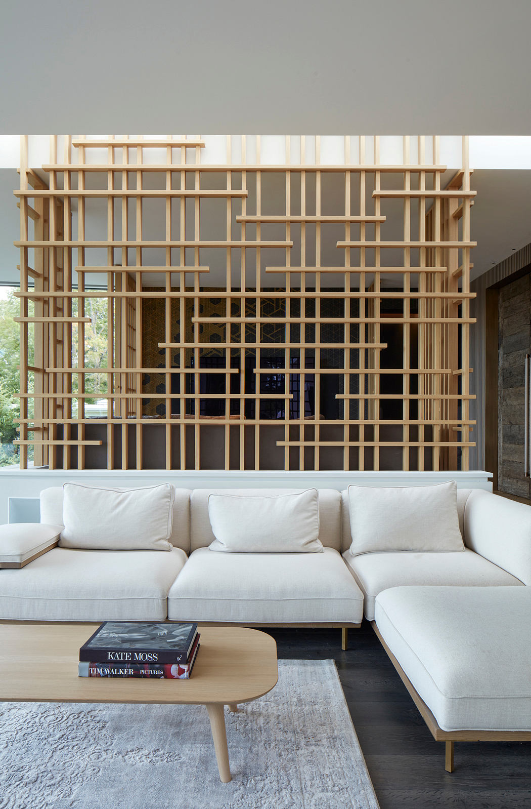 Striking wooden frame feature wall with a modern, open-plan living space.