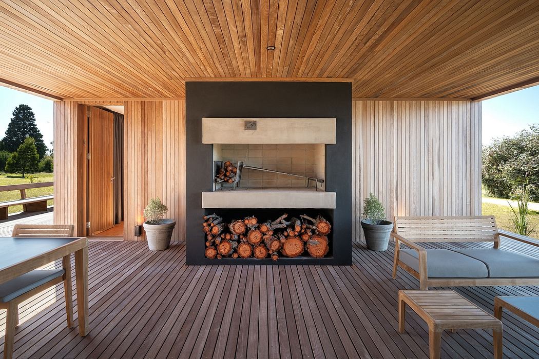 Rustic wood-paneled interior with modern fireplace and outdoor patio seating.