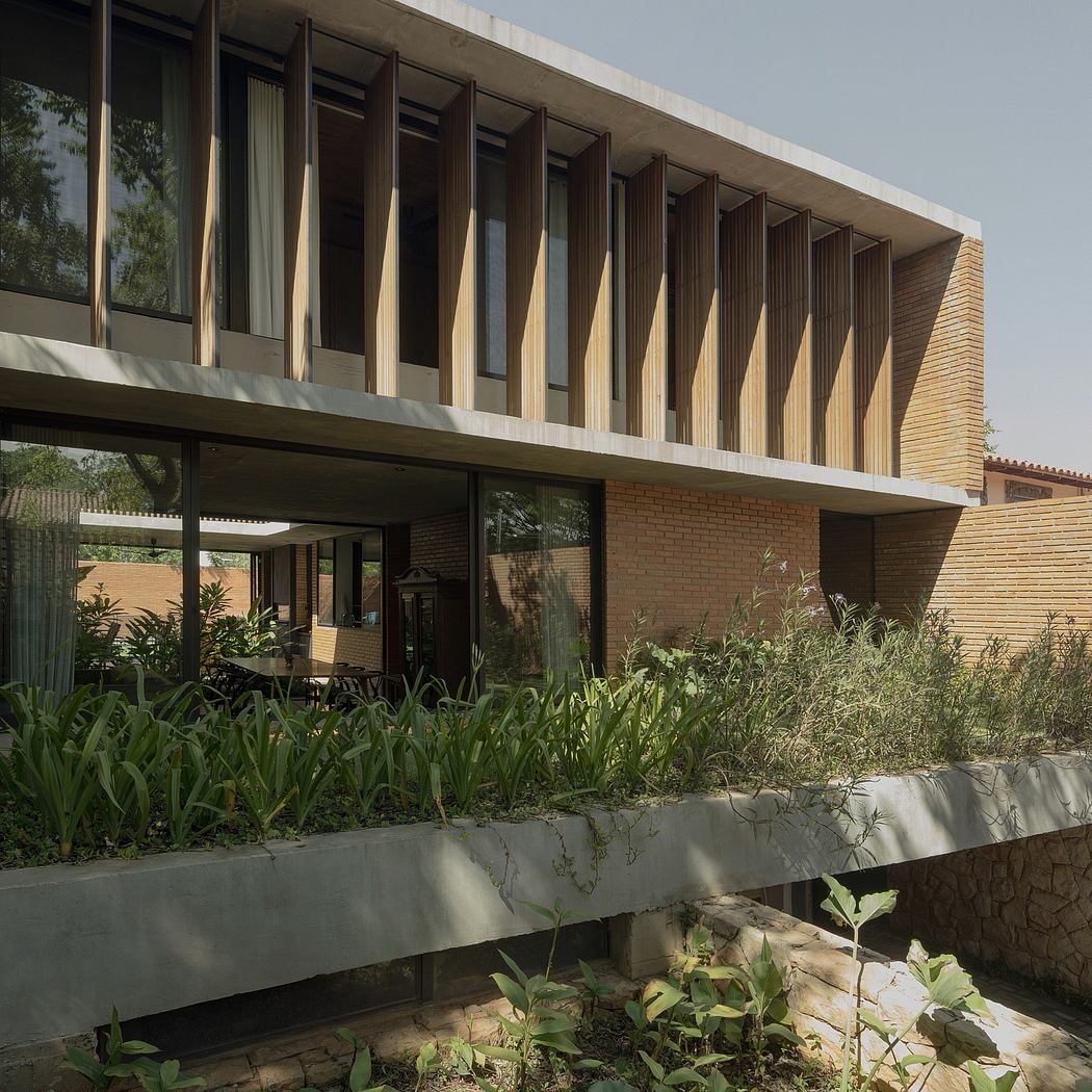 Striking modernist architecture with a series of stepped concrete canopies and lush foliage.
