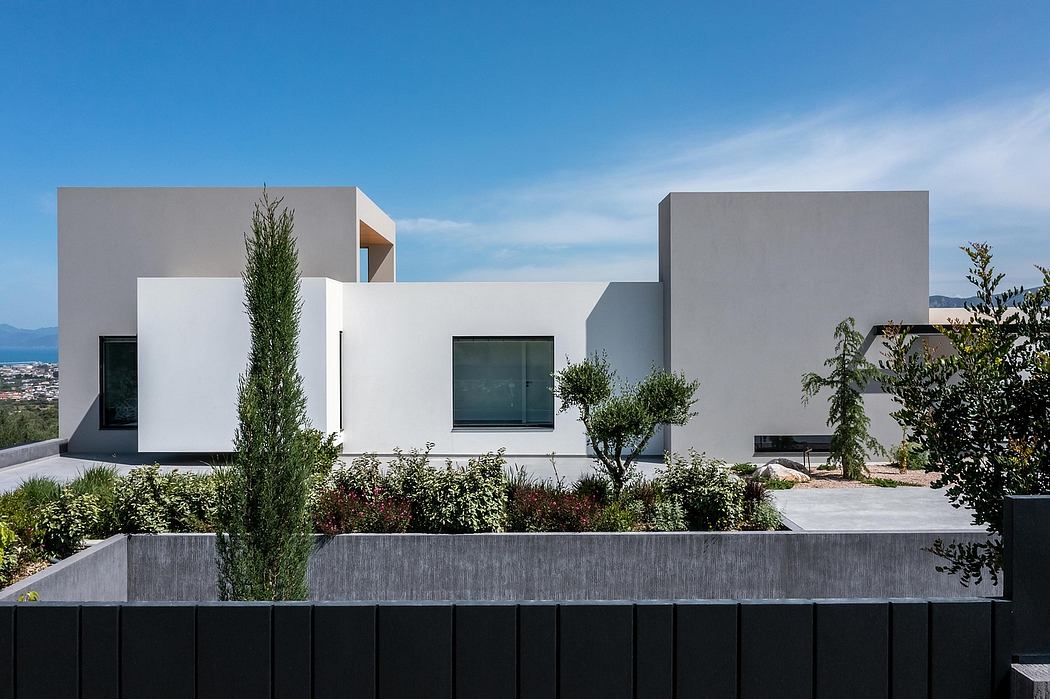 A modern, minimalist villa with clean lines, geometric shapes, and lush greenery.