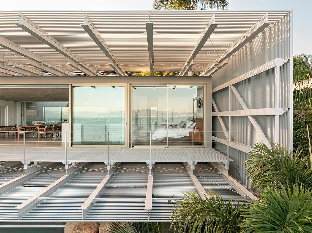 Sleek modern architecture with floor-to-ceiling windows, wooden accents, and lush vegetation.