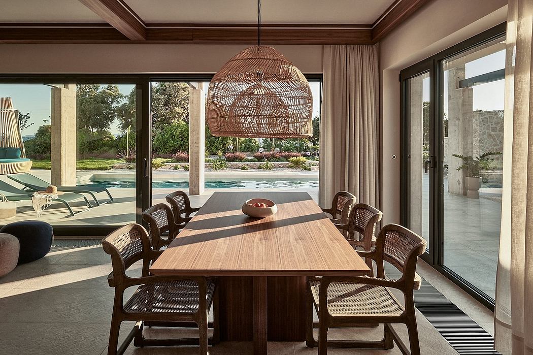 Elegant dining area with wooden table, rattan chairs, and large woven pendant light.