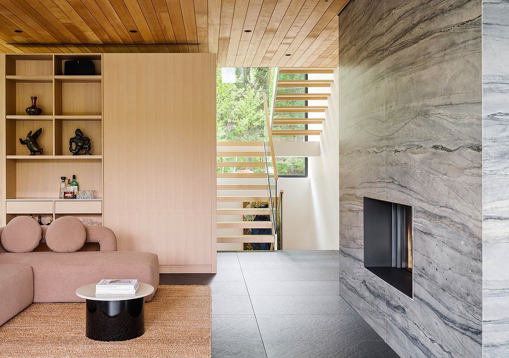 Minimalist living space with wooden ceiling, stone wall, and floating wooden stairs.