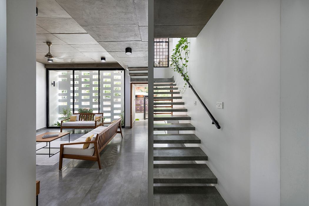 Contemporary, minimalist interior with concrete ceilings, glass partition, and wooden furniture.