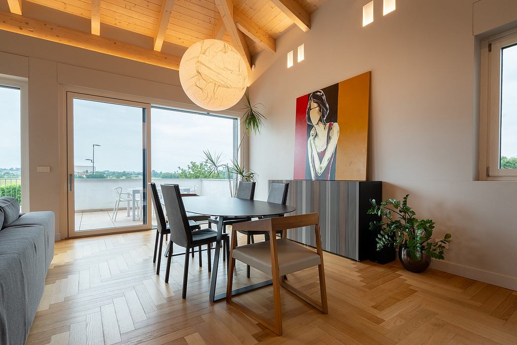 Spacious open-concept dining area with wood-beamed ceiling, large windows, and abstract artwork.