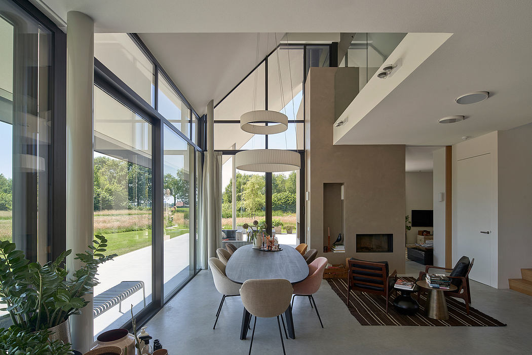 Large open-plan living space with floor-to-ceiling windows, modern lighting, and minimalist decor.