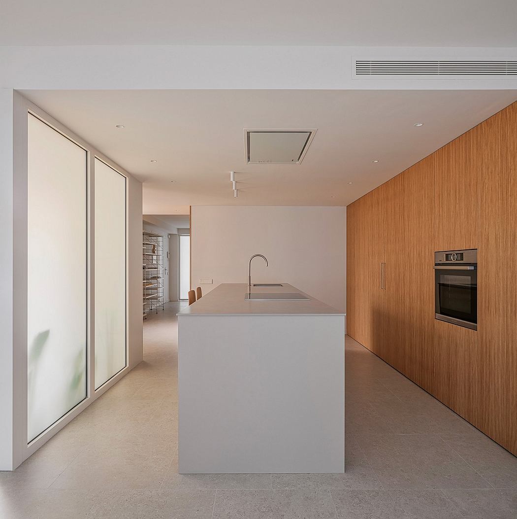 A modern kitchen featuring a sleek, minimalist design with clean lines, neutral colors, and wood accents.