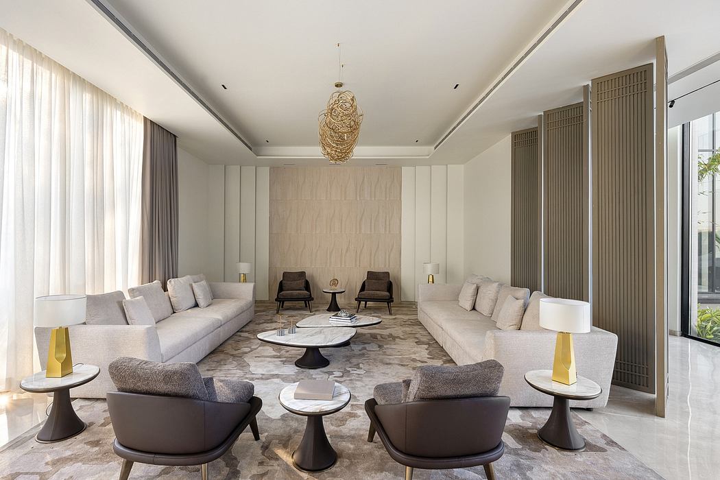 Elegant modern living room with plush sofas, marble coffee table, and statement lighting fixture.