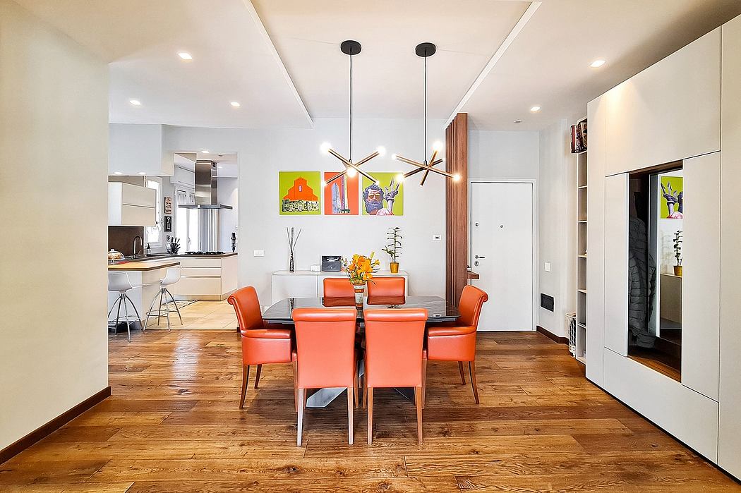 Bright, modern dining area with vibrant orange chairs, wooden floors, and geometric pendant lights.
