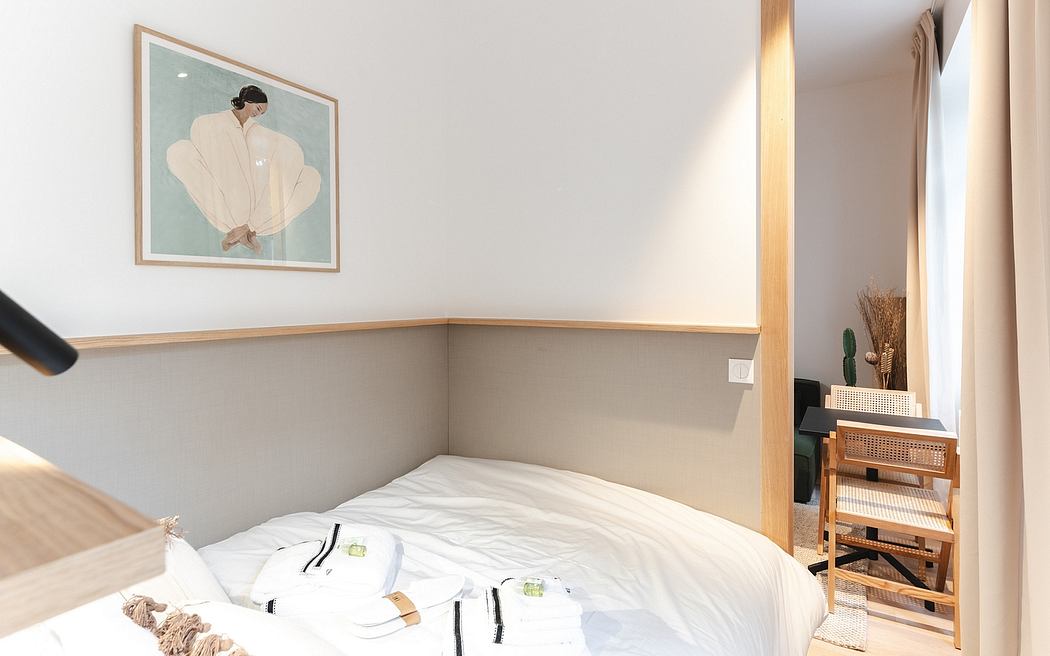 Cozy minimalist bedroom with wooden accents, framed art, and natural textiles.