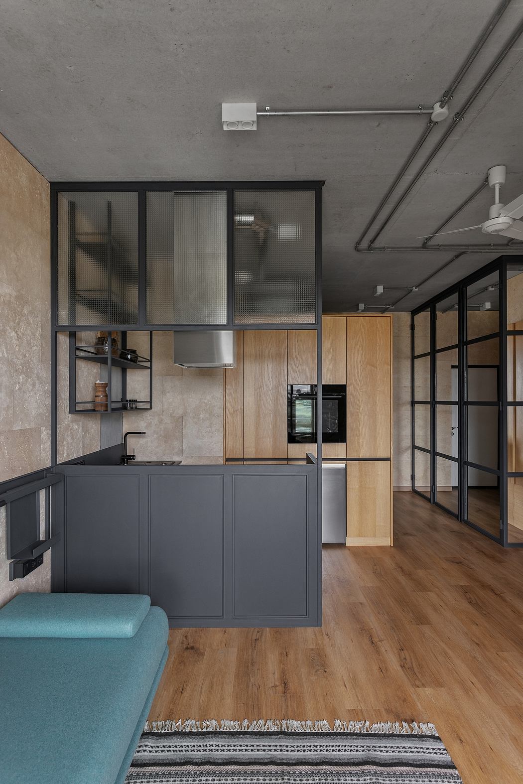 Sleek, modern kitchen with black cabinetry, wood accents, and industrial-style lighting.