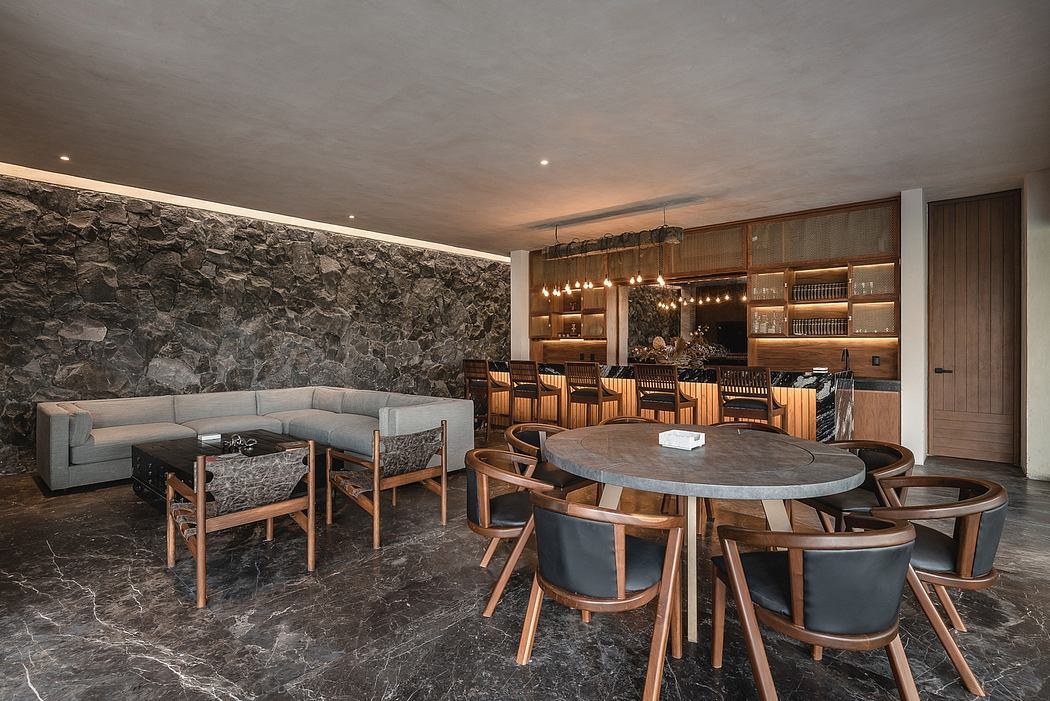 Rustic stone walls, warm wood furnishings, and modern lighting create an inviting ambiance.