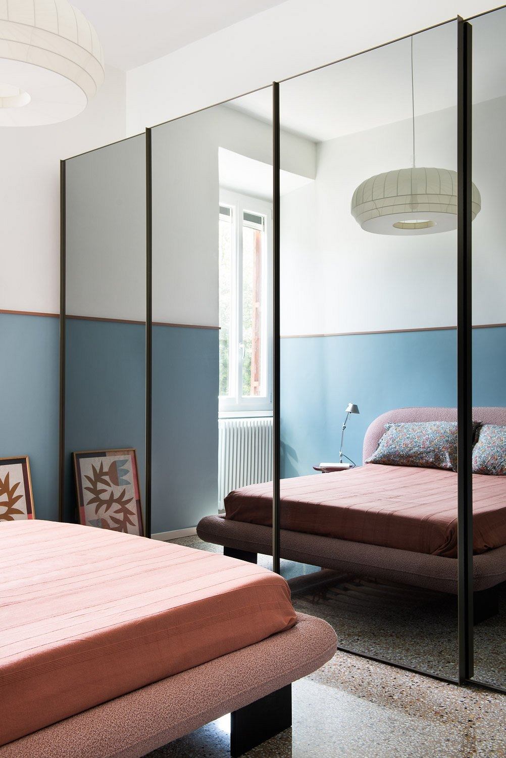 Spacious, minimalist bedroom with modern decor and architectural details.