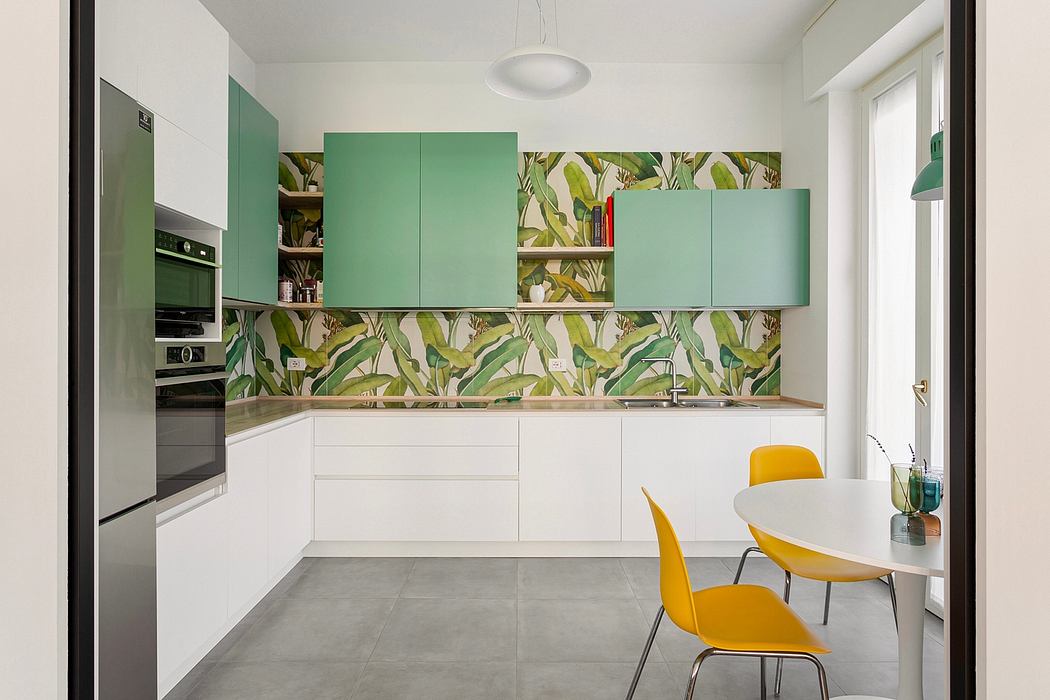 Modern kitchen with lush tropical-inspired backsplash, white cabinetry, and sunny yellow chairs.