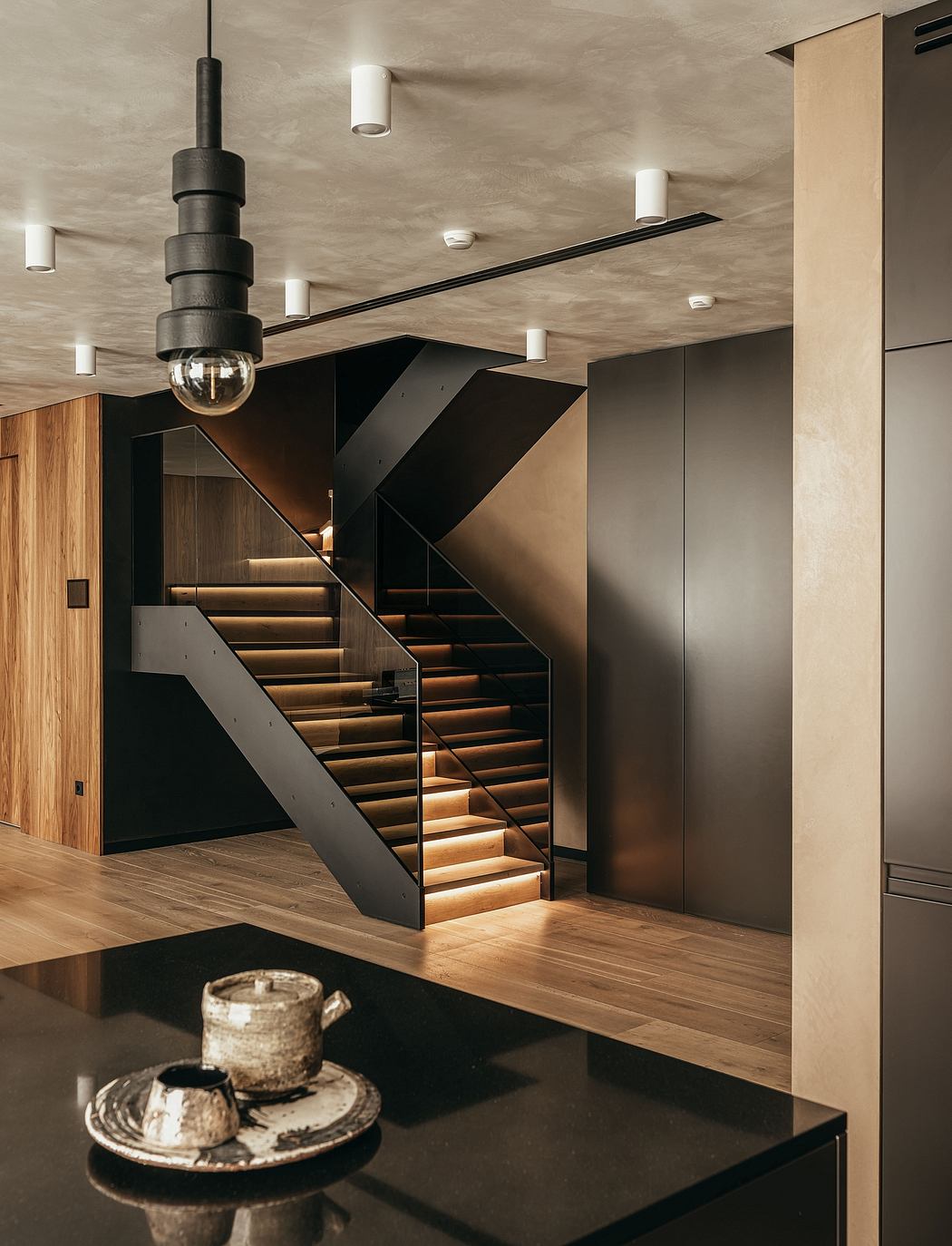 Sleek, modern staircase with contrasting materials and lighting accents.