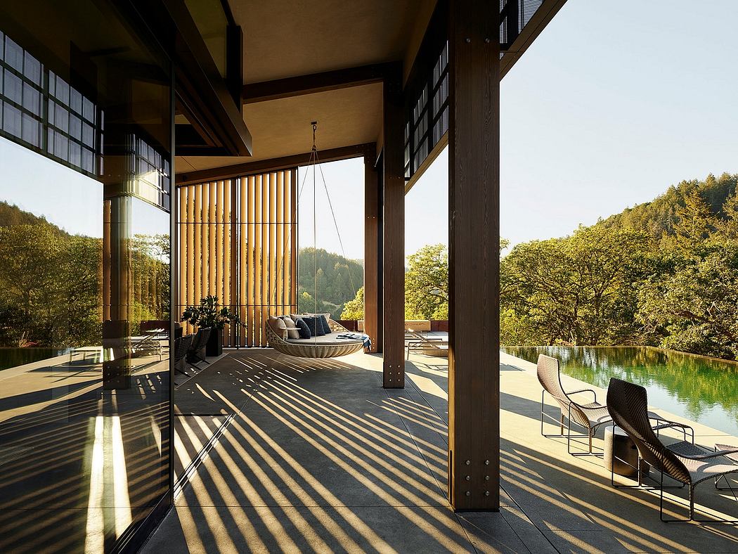 Expansive, open-concept room with timber framing, large windows, and a pool view.