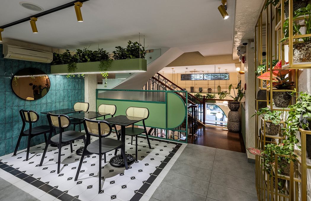 A sleek, modern cafe interior with geometric tile flooring, greenery accents, and brass lighting.