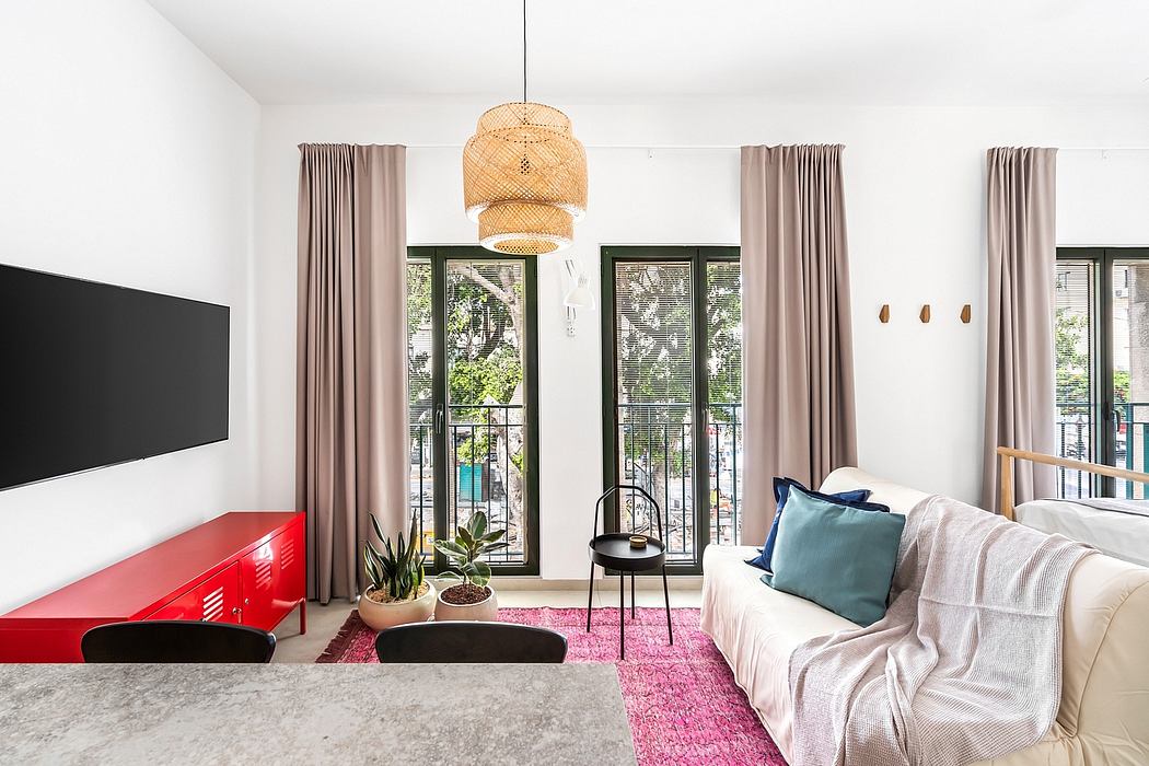 Spacious living room with modern decor, large windows, and a statement rattan light fixture.