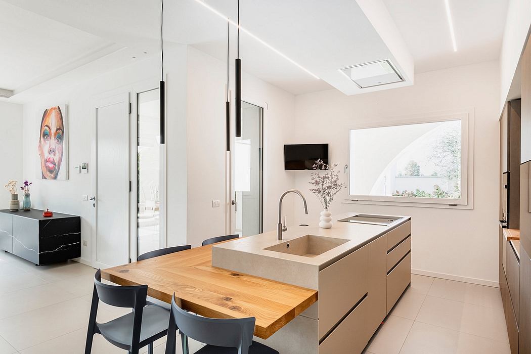 A bright, modern kitchen with wooden countertops, a sink, and pendant lighting fixtures.