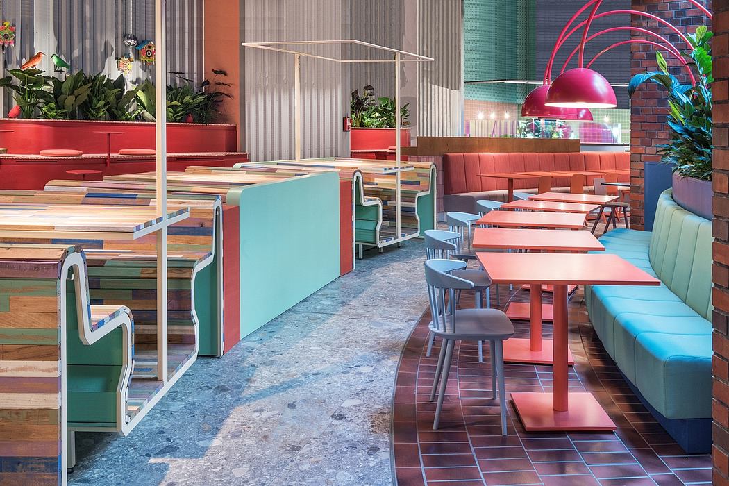 Vibrant, modern interior with colorful tables, seating, and plants creating a cozy ambiance.