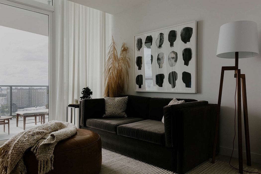 Cozy modern living room with abstract art, plush sofa, and warm lighting accents.