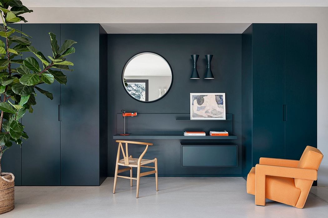 Minimalist interior design with dark green walls, round mirror, and built-in shelving.