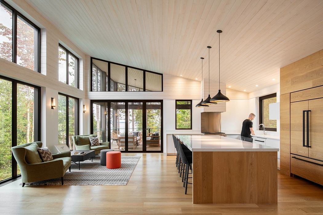 Spacious open-concept kitchen and living area with modern design, wood accents, and large windows.