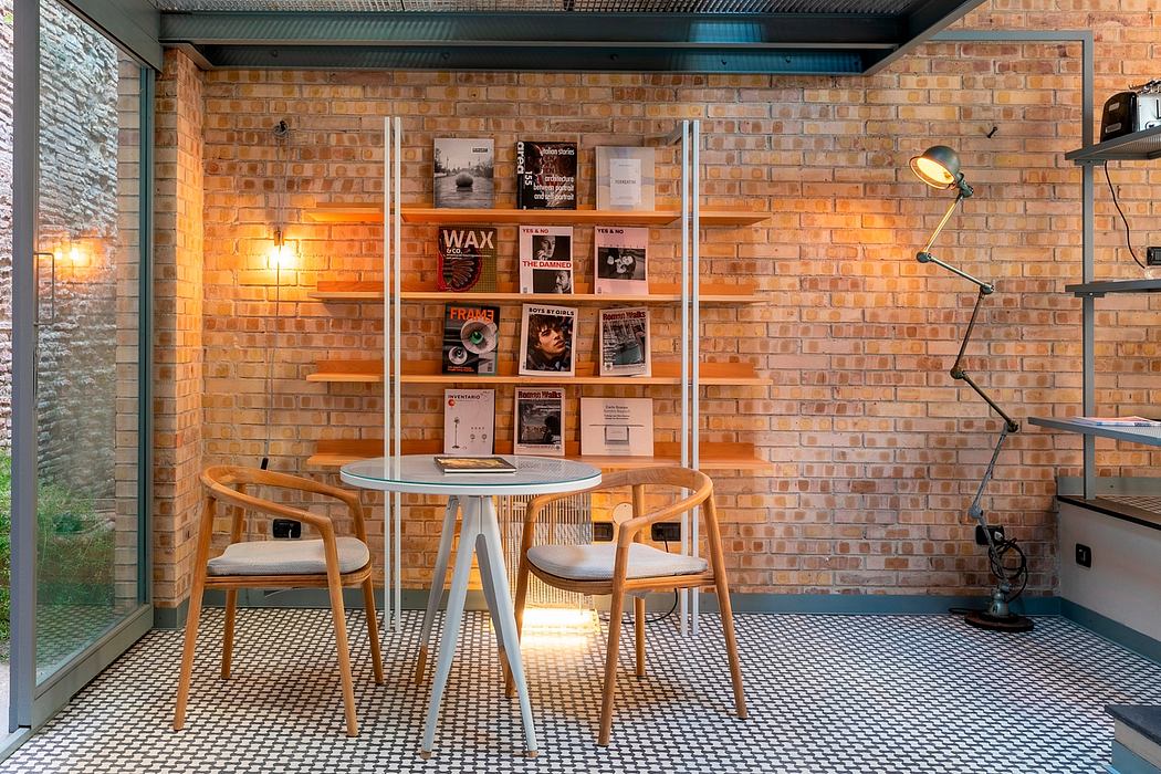 Cozy brick-walled workspace with wooden furniture, shelves, and architectural details.