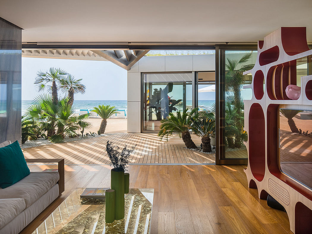 Vibrant modern interior with palm trees, beach view, and geometric design elements.
