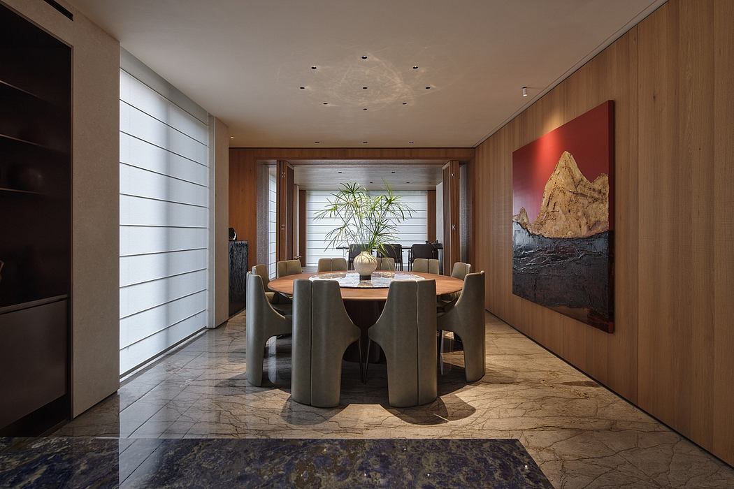 Spacious dining area with modern furnishings, wooden walls, and a large scenic artwork.