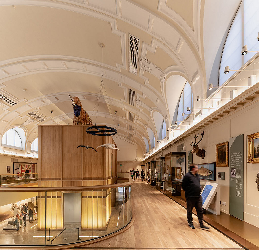 A grand, ornately decorated museum interior with wooden floors, arched ceilings, and displays.