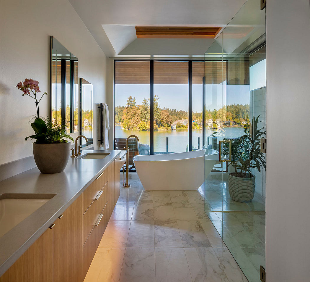 Spacious bathroom with modern fixtures, floor-to-ceiling windows, and beautiful lake view.