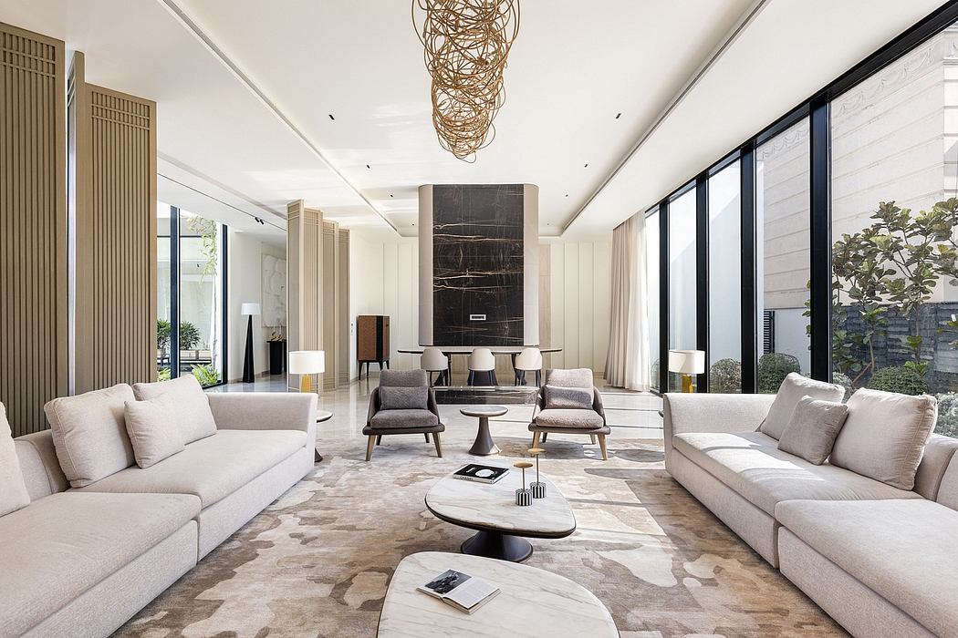 Spacious modern living room with sleek furniture, large windows, and a striking lighting fixture.