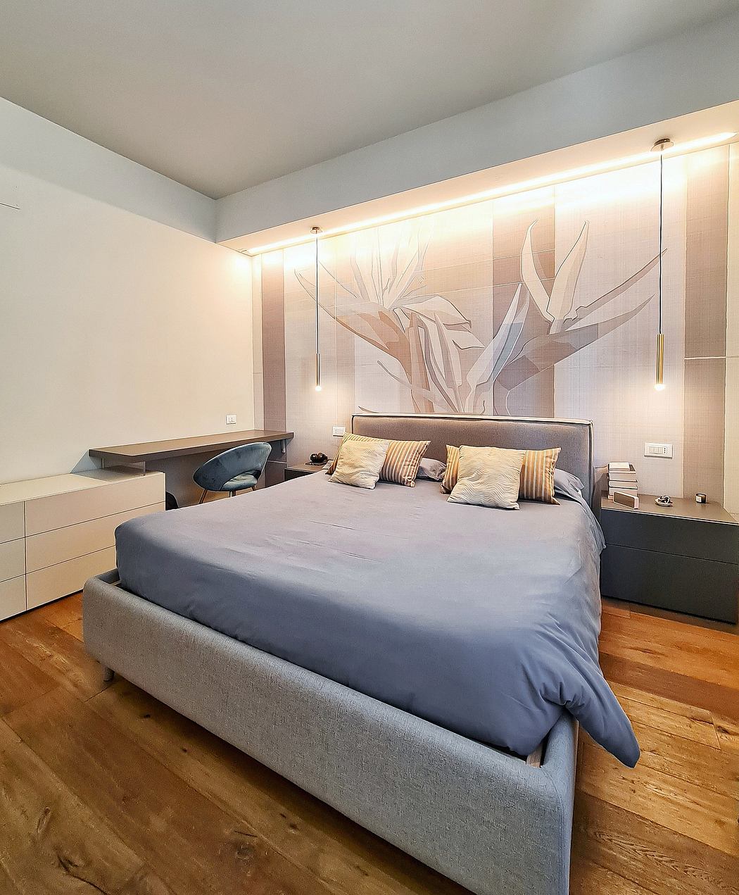 Modern bedroom with minimalist floral mural, raised platform bed, and wooden flooring.