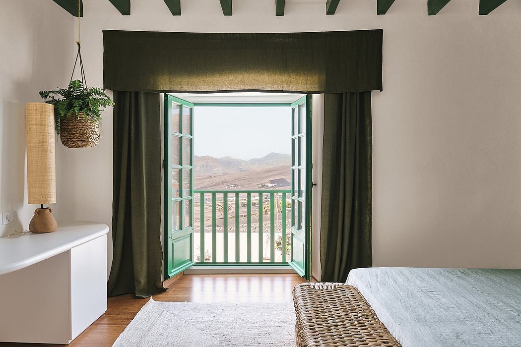 Rustic interior with open balcony overlooking a mountainous landscape. Cozy, natural decor.