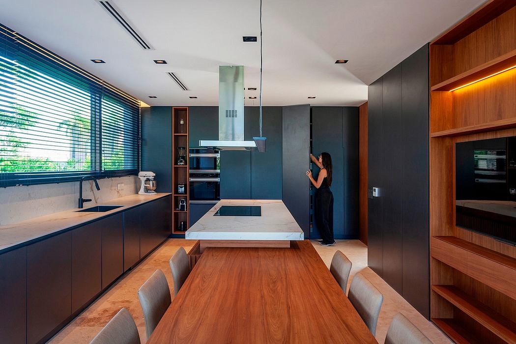 Modern kitchen design with sleek black cabinets, wood accents, and functional layout.