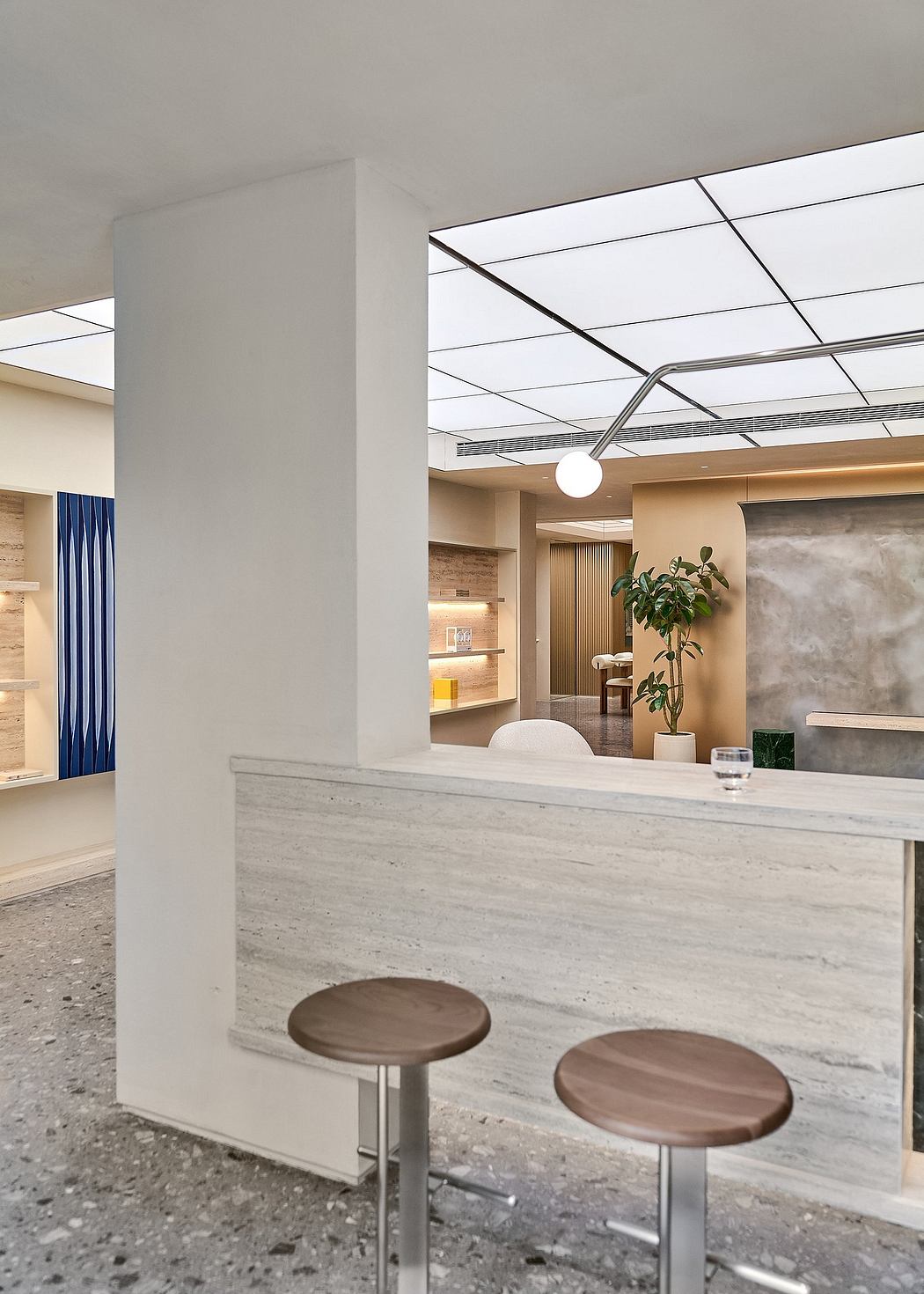 Modern, minimalist interior design with a sleek reception desk, wood accents, and recessed lighting.
