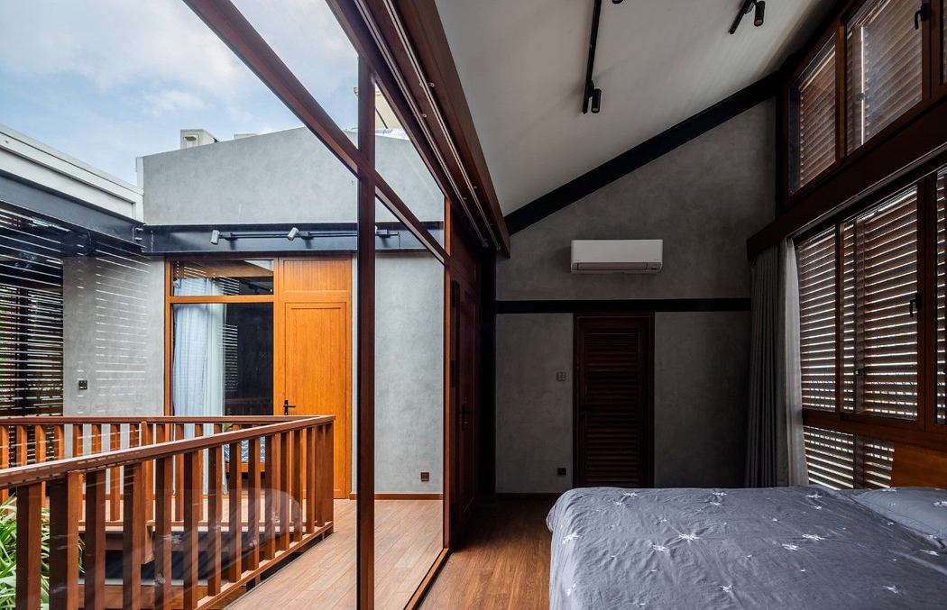 Contemporary bedroom with wooden balcony, clean lines, and natural light.