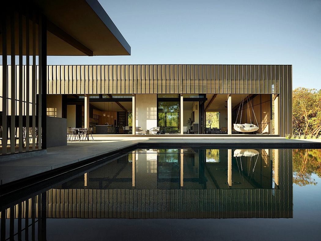 Sleek modern architecture with reflecting pool, patio, and open interior space.
